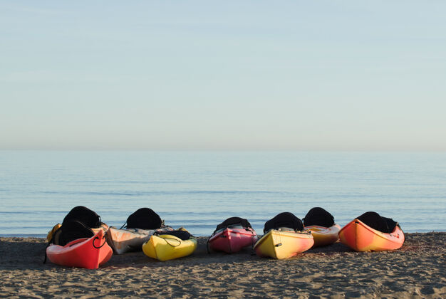 水沙滩上有一群独木舟 背景是大海生活方式沙滩旅游