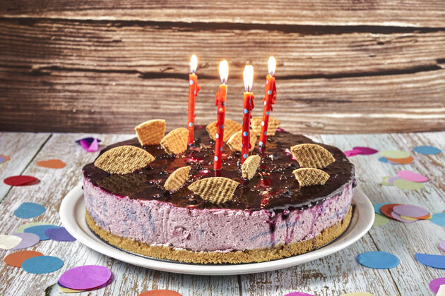 糕点一个森林水果慕斯蛋糕 上面装饰着饼干和四根蜡烛蛋糕食品奶油