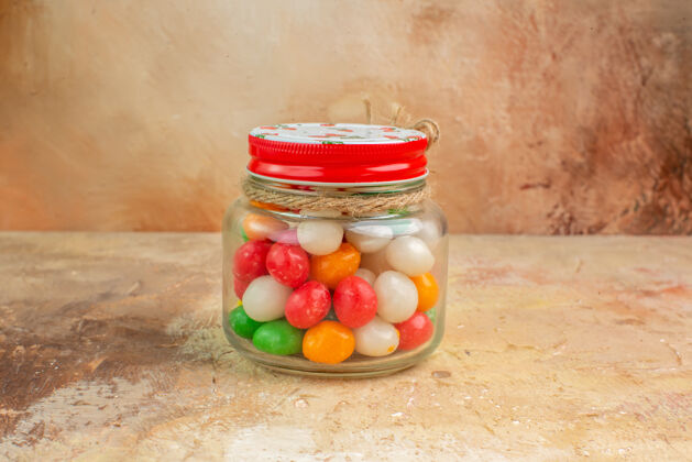 水果前视图彩色糖果玻璃罐内的灯光背景橘子饮食糖