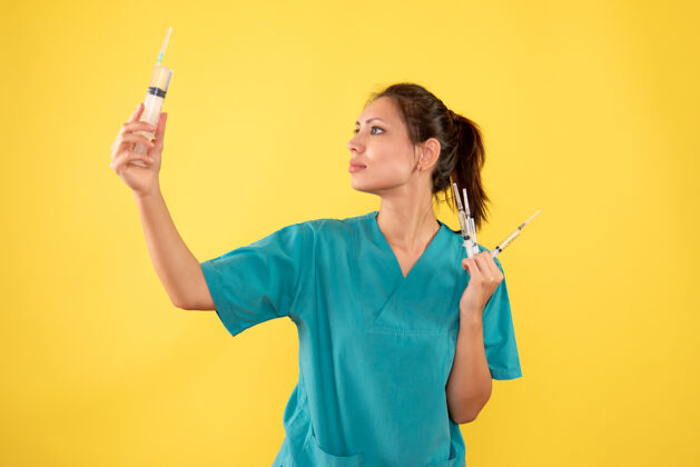 肖像正面图黄桌上拿着针剂的女医生医院病色医护病毒护士健康前面视图成人