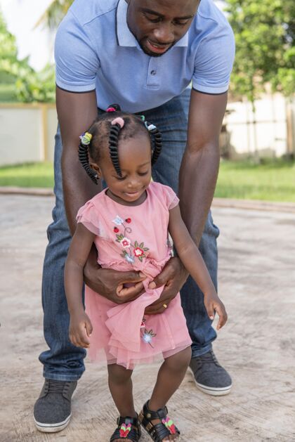 年轻爸爸抱着女儿走路女儿小女孩