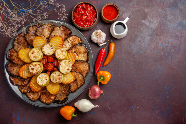 膳食俯瞰美味的烤蔬菜土豆和茄子上的深色背景餐烤箱烹饪烤蔬菜盘子烤箱土豆