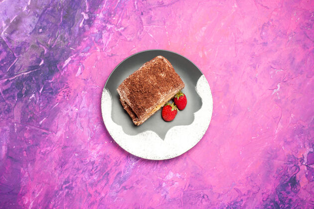 餐粉红色表面上有草莓的美味甜面包卷俯视图胡椒派甜点