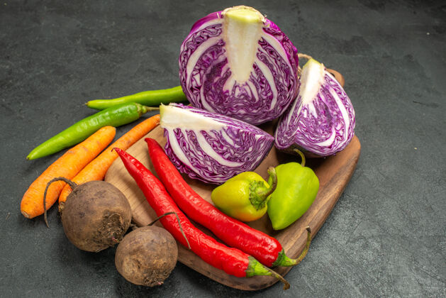 水果前视图新鲜的红色卷心菜搭配其他蔬菜上深色餐桌饮食熟透沙拉健康沙拉农产品新鲜