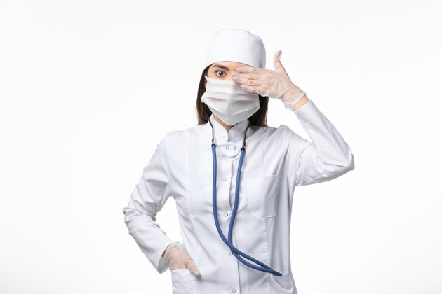 到期正面图：女医生穿着白色无菌医疗服 带着口罩 因为柯维德-光壁病柯维德-大流行病毒病疾病医生灭菌