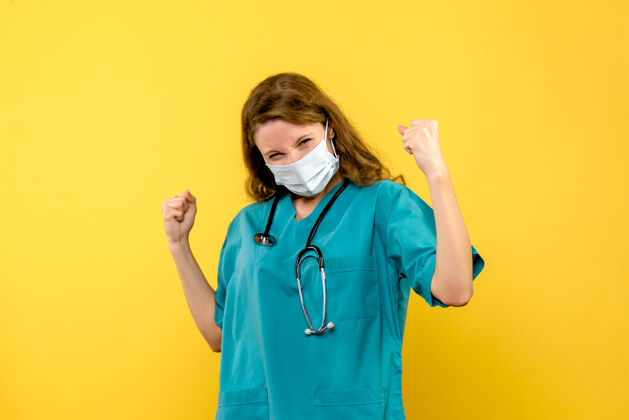 人正面图黄色空间上的女医生戴着面具欢呼雀跃医生女医生医疗器械