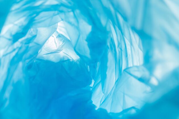 皱褶蓝色塑料袋的平面布置皱纹包装背景