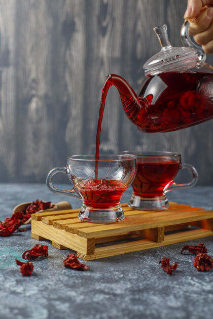 草药热木槿茶在一个玻璃杯子和玻璃茶壶杯植物排毒