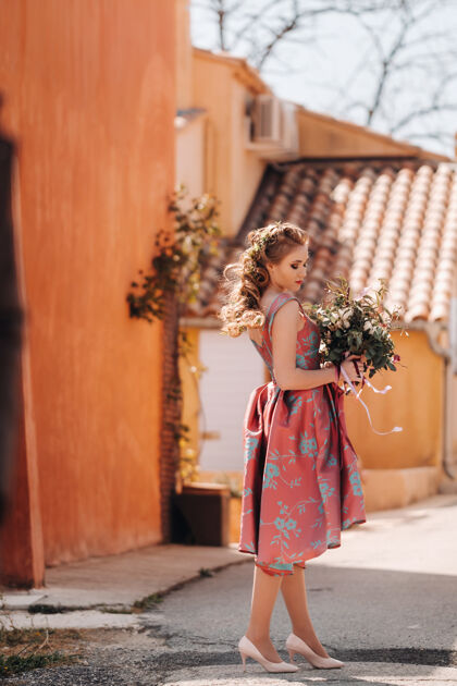 花束在法国的乡村 一个穿着漂亮裙子 手持一束鲜花的年轻模特儿春天普罗旺斯村里的花童假日女人头发
