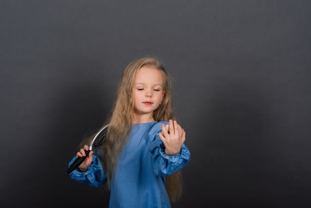 小女孩用梳子缠住头发和发刷感觉疼痛 工作室发型长好看