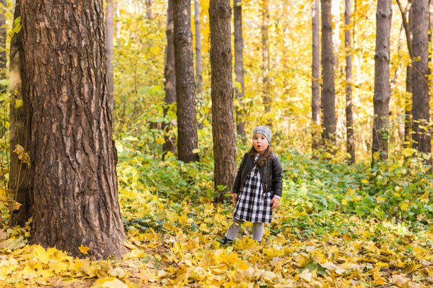 秋天秋天 童年和季节概念-小女孩在秋天公园玩公园户外黄色