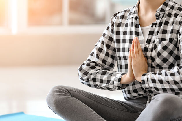 休闲运动型年轻女子在家练习瑜伽心灵放松平静