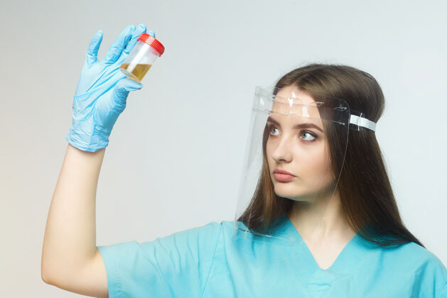 护士女医生手里拿着一瓶尿检医生年轻分析