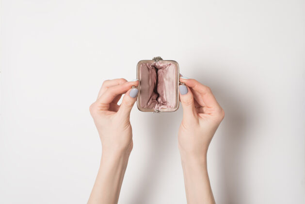 改变空打开金属钱包在女性手中的一个轻背景时尚商业钱包