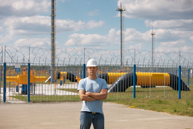 工作储气库背景上戴头盔工作的人的肖像男性煤气工作