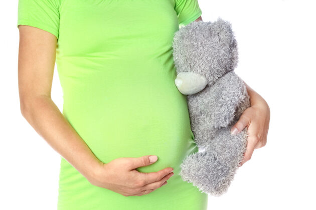 父母快乐的怀孕女孩躺在白色的背景上成人怀孕身体