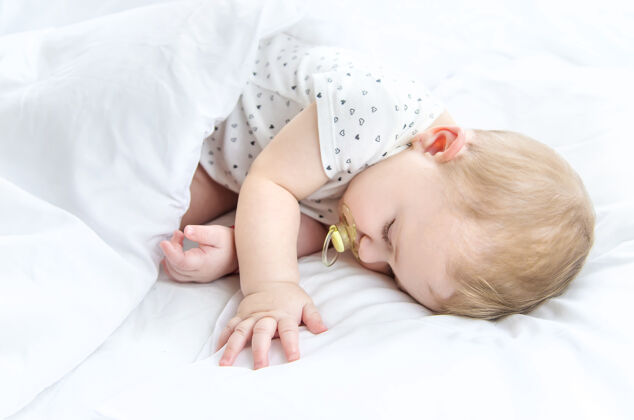 婴儿宝宝睡在白色的床上休息脸可爱