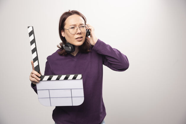 镜头年轻女子拿着一个白色的电影院磁带高质量的照片女人磁带人类