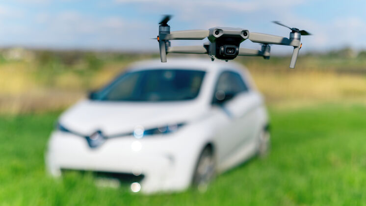 汽车飞行无人机在大自然中射击一辆停着的电动车色彩田野农业