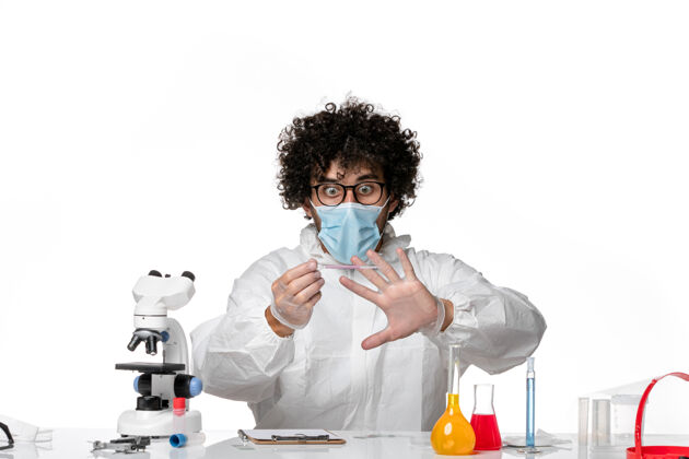 人男医生穿着防护服 戴着口罩 用白色溶液工作套装流行病实验室
