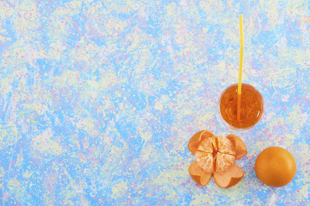 新鲜一杯橘子汁 周围有柑桔 蓝色背景 顶视图 高质量照片酒精鸡尾酒冰沙