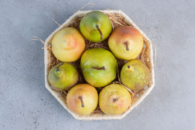 营养一小包各式各样的梨放在大理石背景的白色篮子里品种水果美味
