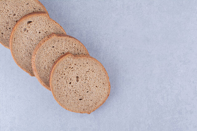 面包把黑面包片排列在大理石表面饮食面粉馒头