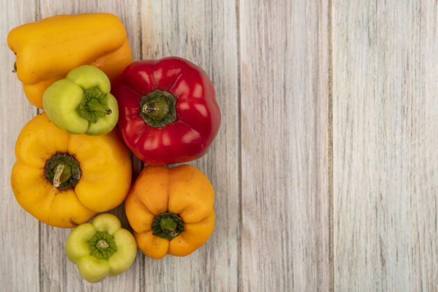 健康顶视图新鲜的彩色甜椒隔离在灰色的木制表面与复制空间烹饪营养铃铛