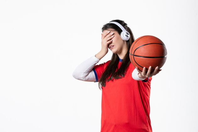 白色正面图：穿着运动服的年轻女子打篮球微笑肖像年轻女性