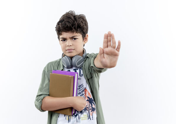 停严格的小男生拿着书 在白色的纸上显示停止的手势表情严格小