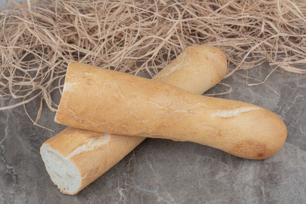 地壳在大理石表面切半块法式面包食品硬皮美食