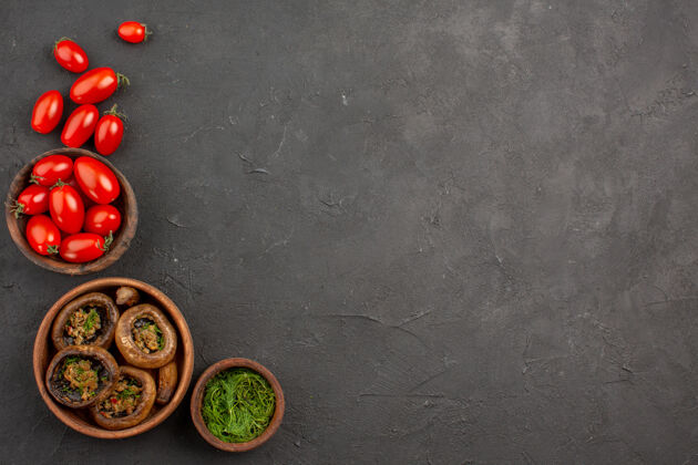 意大利面顶视图煮熟的蘑菇和西红柿在黑暗的桌子上蘑菇野生面食西红柿蘑菇食物