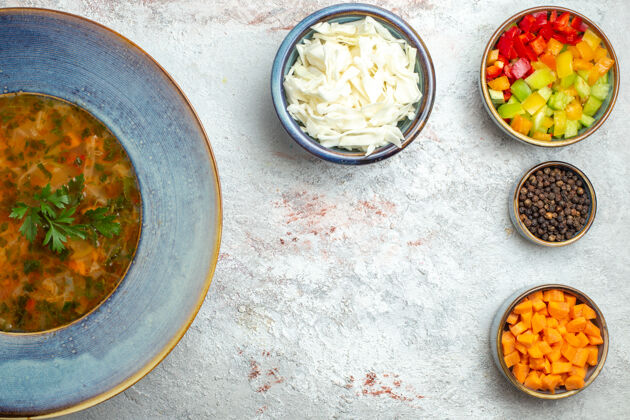 午餐顶视图热蔬菜汤与切片蔬菜在白色空间菜肴碗晚餐