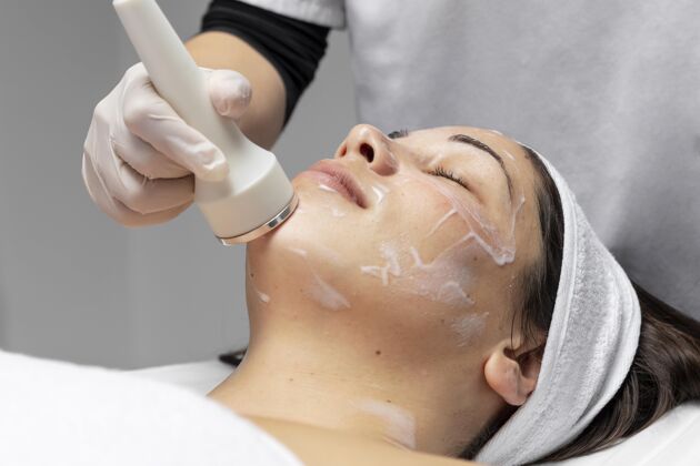 美容正在做面部护理的年轻女子皮肤护理美容师治疗