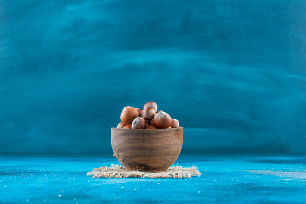 美味榛子在碗里的纹理上呈蓝色表面风味营养碗
