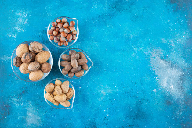 坚果各种各样的坚果放在蓝色的碗上风味碗杏仁