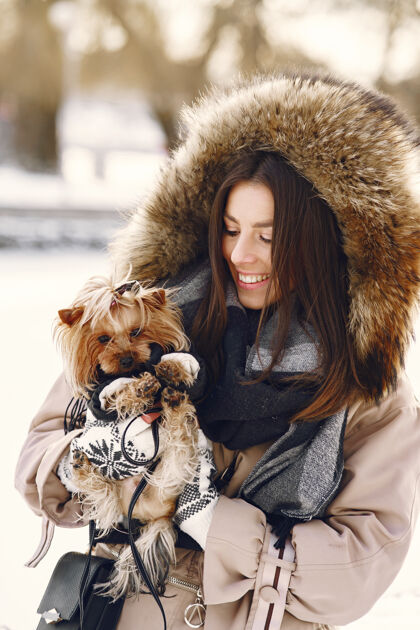 一起可爱的女孩和她的狗在冬季公园散步朋友肖像欢呼