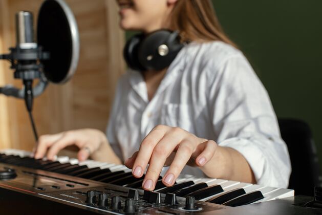 家用女音乐家在室内弹奏钢琴键盘和录制歌曲乐器钢琴键盘音乐