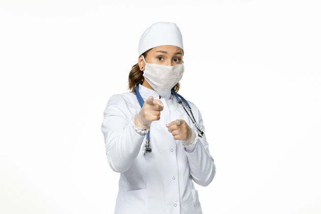 医生正面图女医生穿着白色医疗服 戴着口罩 因冠状病毒对轻白壁病毒病大流行光医学冠状病毒