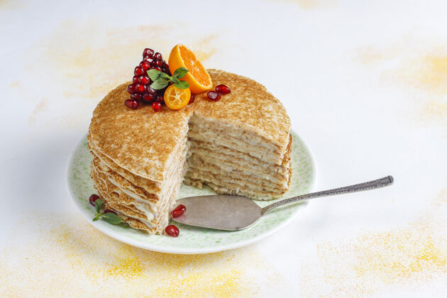 自制用石榴籽和柑桔装饰的美味自制绉饼糕点法式绉饼