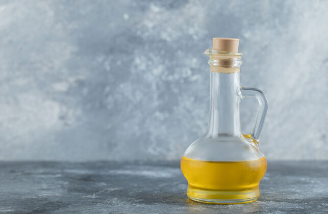 饮食灰色背景上的一瓶油高质量的照片生产健康物体