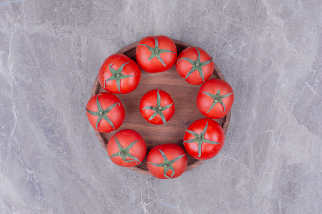 可口西红柿被隔离在大理石上的木盘里四季多汁热带