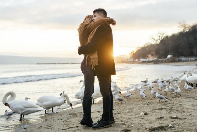 男人冬季沙滩情侣拥抱侧视图季节消遣鸟