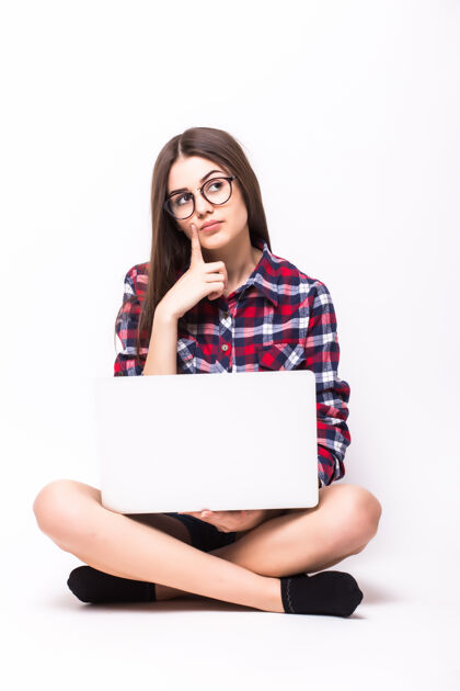 欢呼一个年轻女子坐在地板上 白色的笔记本电脑漂亮年轻电脑