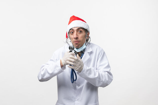 圣诞节前视图男性医生用听诊器感染病毒听诊器制服病毒