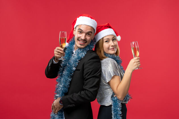 肖像正面图年轻夫妇庆祝新年红墙假日爱圣诞节幸福美丽风景