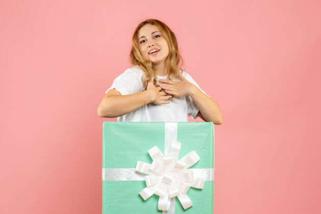 年轻女性蓝色礼品盒内的年轻女性正面图圣诞节成人节日