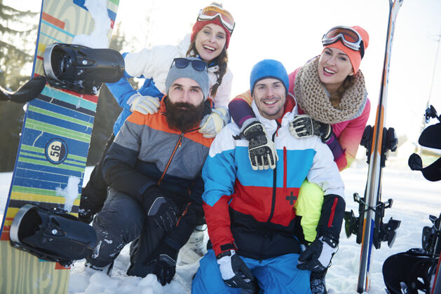 顽皮滑雪板朋友摆姿势享受极限运动雪
