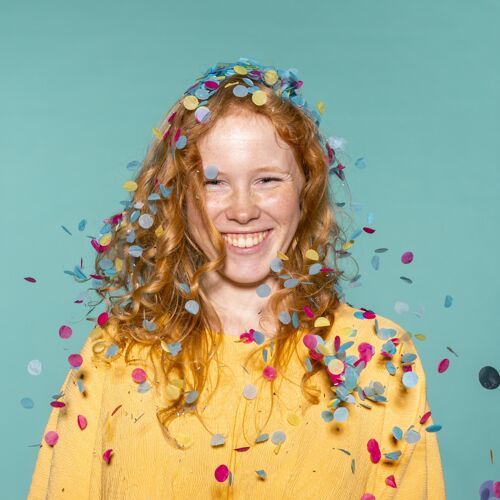 活动笑容可掬的红发女人头发里夹着五彩纸屑在聚会庆祝乐趣女人