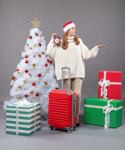 帽子正面图金色圣诞女孩拿着红色的手提箱拿着红色的闹钟快乐礼物警报